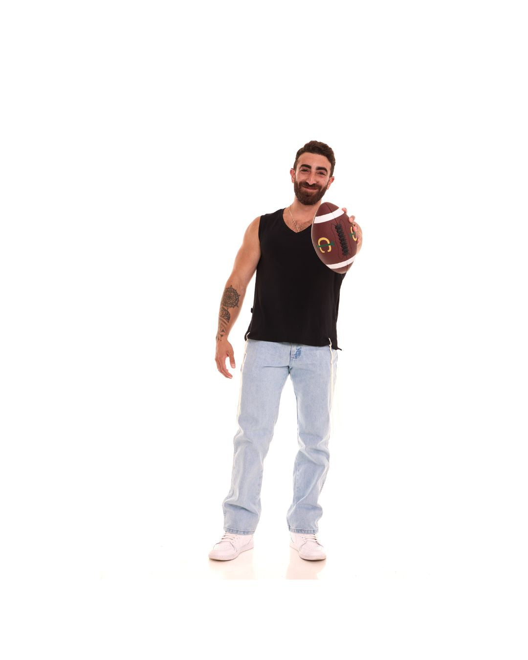 The black Le'Shem Tank worn with jeans, holding a football